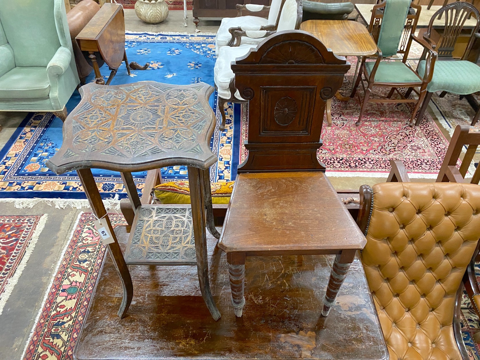 A late Victorian aesthetic movement walnut hall chair, height 88cm together with a chip carved two tier occasional table